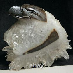 Natural quartz crystal cluster mineral specimen. Fine hand-carved bald eagle